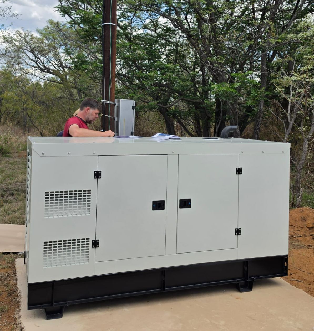 80kVA silent diesel generator installed on its concrete plinth at the school camp